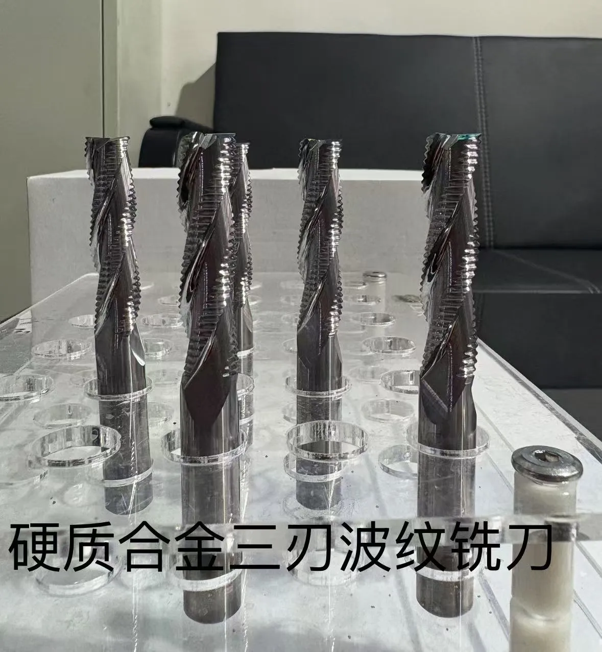 Custom ground solid carbide end mills photographed in the workshop before coating